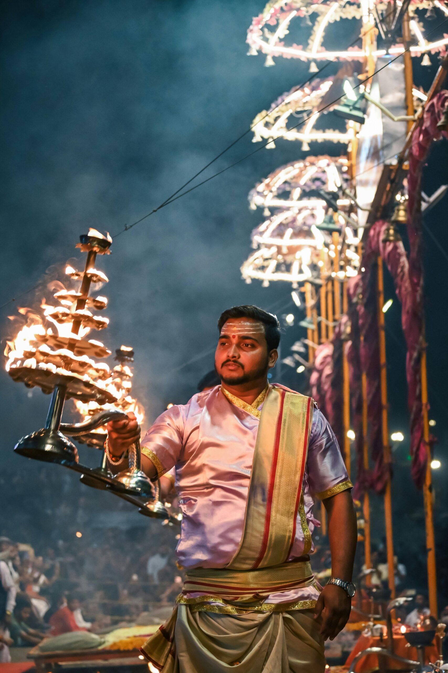 Devotees offering aarti on the banks of the Ganges River during a spiritual ritual.